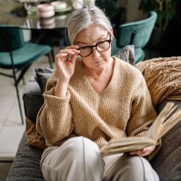 Woman reading on couch.