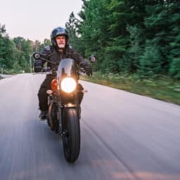 Man riding his motorbike in the countryside at dawn