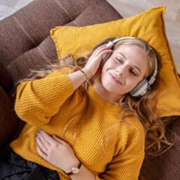 Young woman relaxing at home and listening music